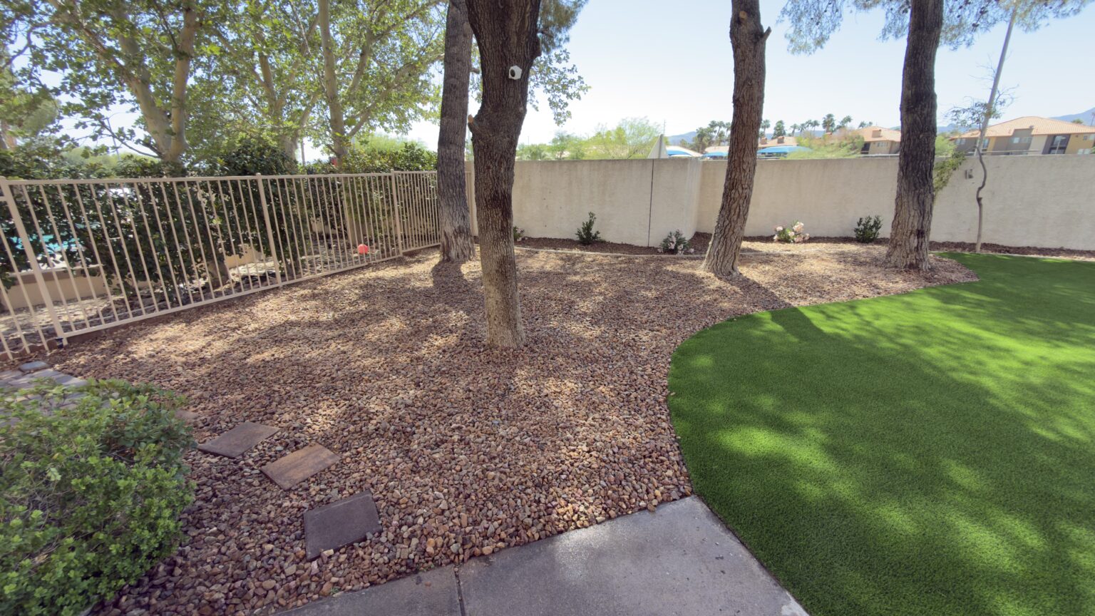 Backyard after rock coverage and turf installation